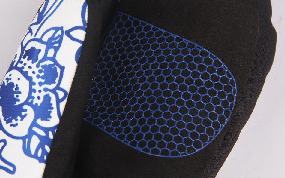 Close-up of waterproof ski gloves with checkered polyester material and blue hexagonal pattern design.