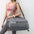 Large women's gym and travel bag in gray, featuring multiple compartments and a shoulder strap, perfect for fitness and outdoor activities.