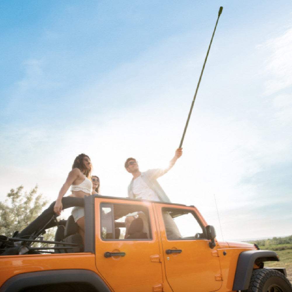 super long selfie stick with 3m reach used by people on a jeep