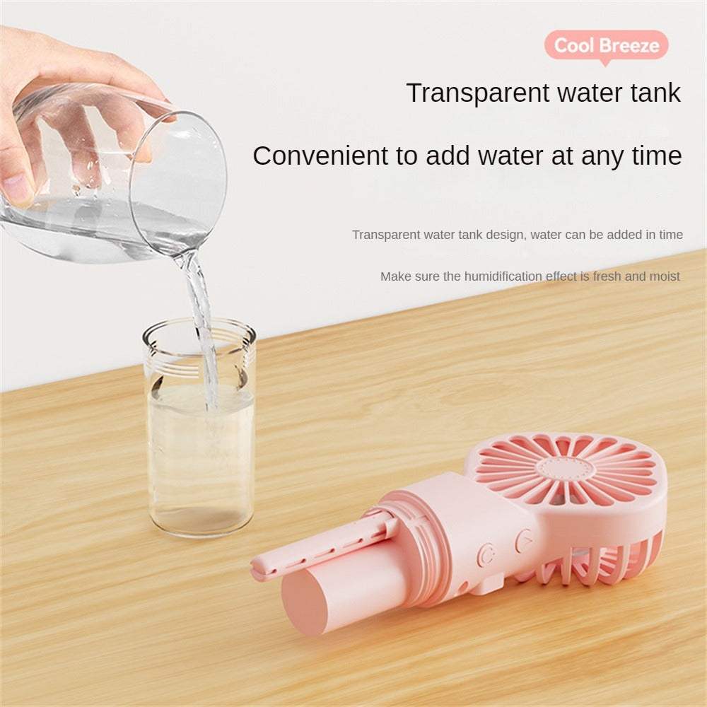 Humidification fan with transparent water tank on wooden surface, pink color.