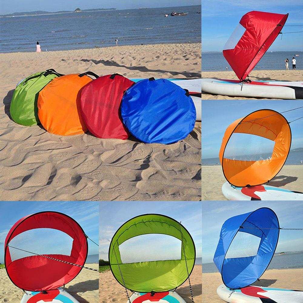 Kayak sail for kayaking and paddle boarding on a beach with various colors, featuring waterproof fabric and transparent windows.